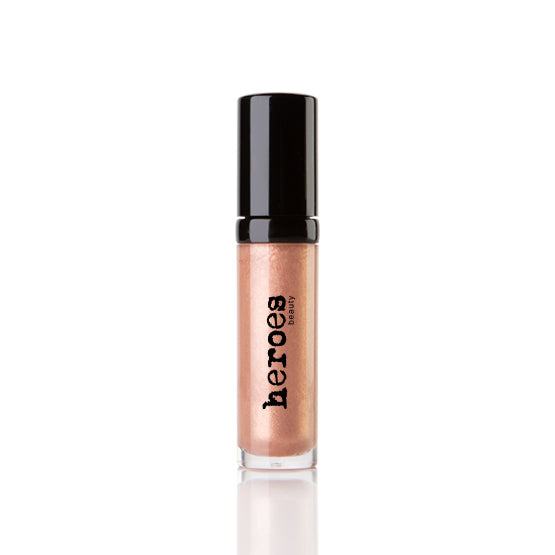 Image of a golden shimmering lip gloss. Neutral color with black lid.