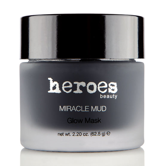 Image of a frosted glass 2.20 ounce jar with a black lid containing our dark gray Miracle Mud Glow Mask.