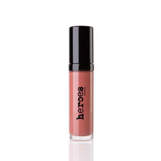 Image of a short clear tube with black lid. It contains our Luxe Lip Gloss in Nashville Nude a coral colored lip gloss.