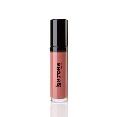 Image of a short clear tube with black lid.  It contains our Luxe Lip Gloss in Nashville Nude a coral colored lip gloss. 