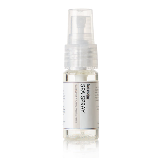 Image of a travel size, .05 ounce clear pump bottle.  It contains eucalyptus, cherrywood and vanilla essential oil spa spray.