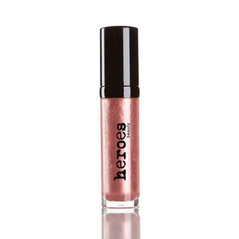 Image of a short clear tube with black lid.  It contains our Luxe Lip Gloss in a medium rose colored shimmery pink lip gloss. 