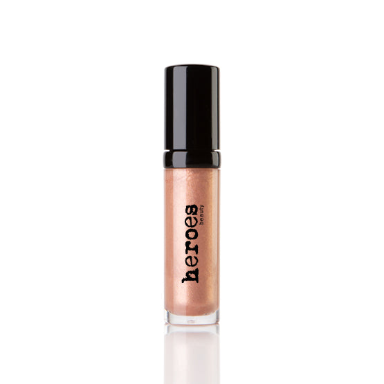 Image of a golden shimmering lip gloss.  Neutral color with black lid.