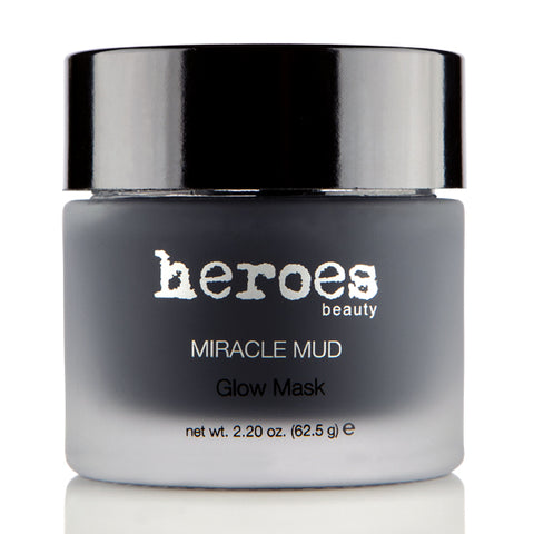 Image of a frosted glass 2.20 ounce jar with a black lid containing our dark gray Miracle Mud Glow Mask. 