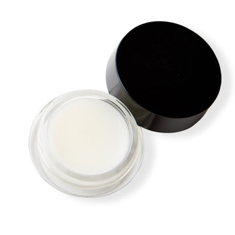 Small clear jar with black lid containing a eye balm. 